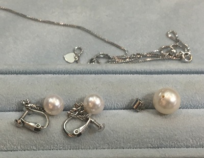 トレイに並べられた真珠のイヤリングとペンダント