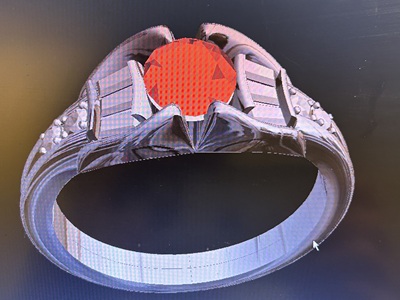 CADソフトの画面に映し出されたリメイク後のリングの3D完成モデル。中央の赤いルビーを挟むようにサイドにダイヤモンドが配置されている